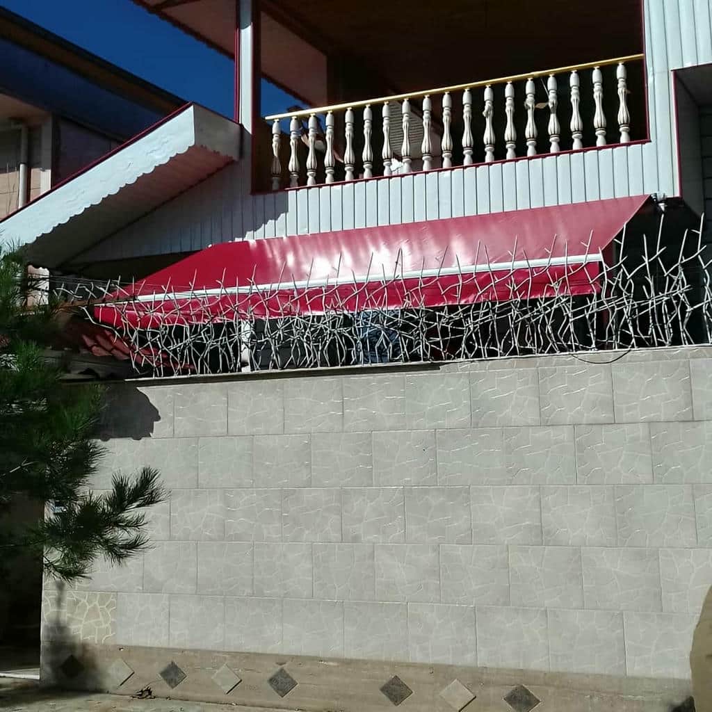 سایه بان متحرک زیتونی بر فراز پنجره آشپزخانه